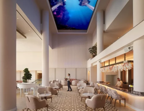 Grand Lobby featuring a spacious lounge area with seating, a white piano, and a large 3D digital ceiling display depicting an underwater scene, Olympic Lagoon Resort Paphos